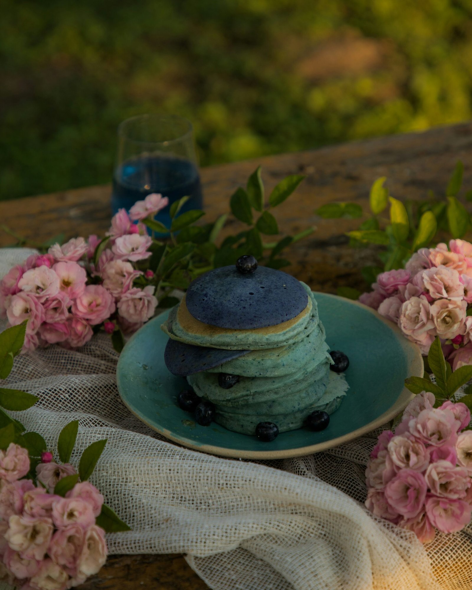 a stack of pancakes sitting on top of a blue plate