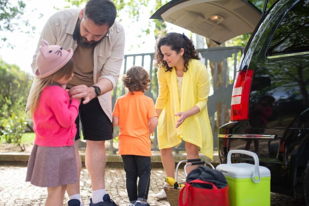 Cheerful family loading their car for a day trip